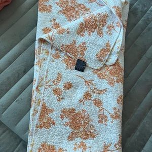 Orange and white floral quilt